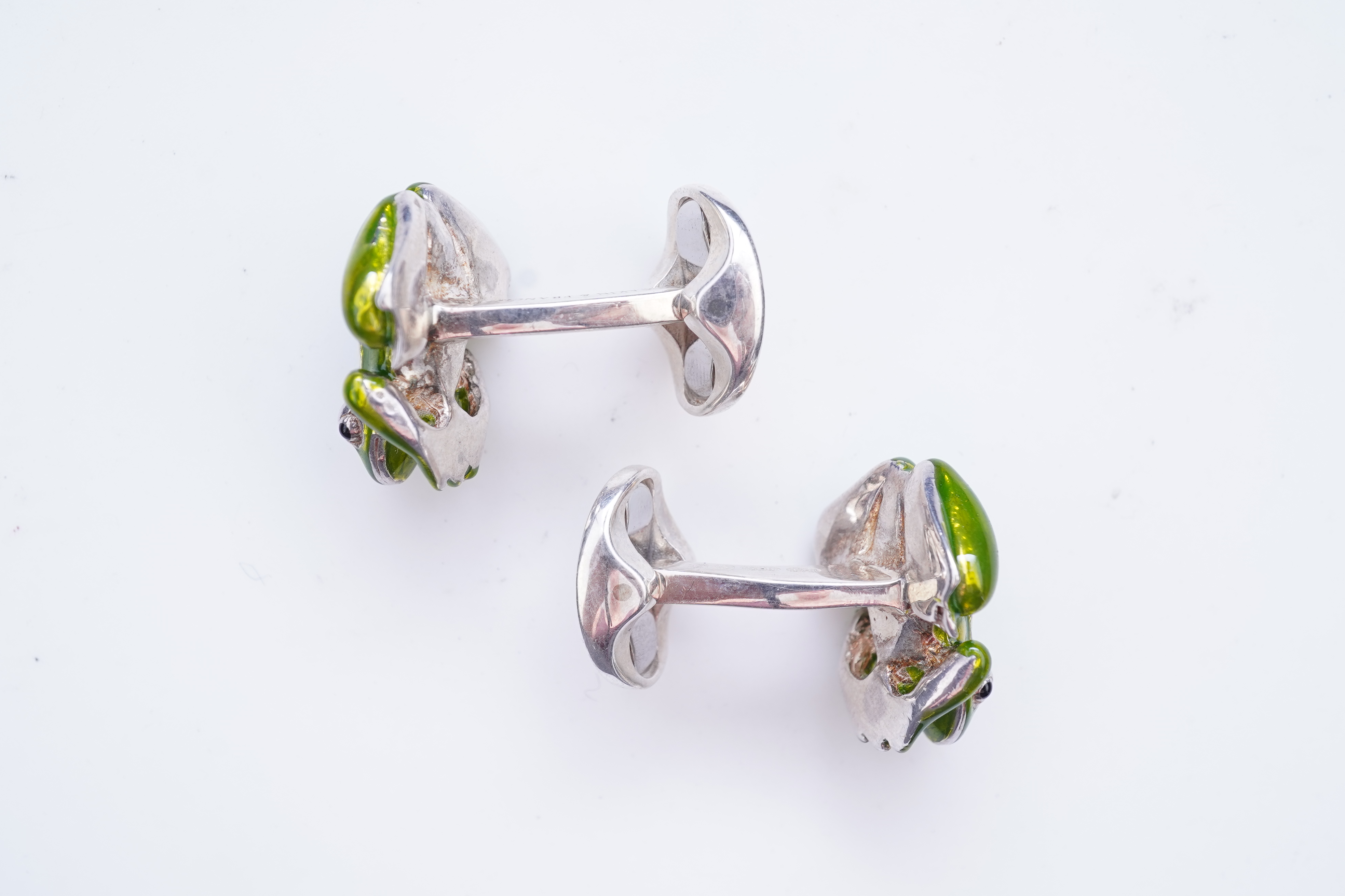 A modern pair of silver and polychrome enamel set oval cufflinks, 18mm.